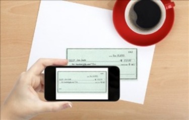 Cell phone image of mobile deposit check and coffee cup